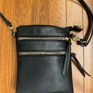 Elegant Black Crossbody Bag with Gold Zippers